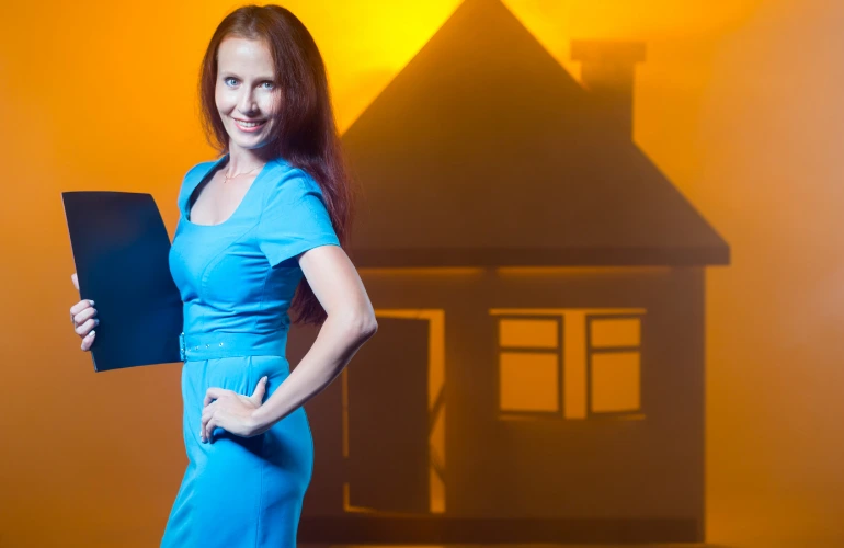 Woman realtor with a home silhouette in background