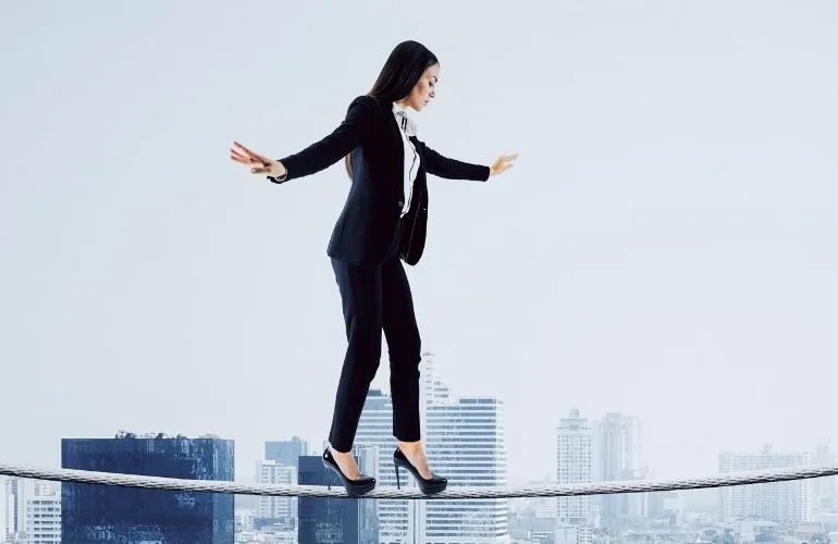 Side view of young european businesswoman balancing on city and sky background