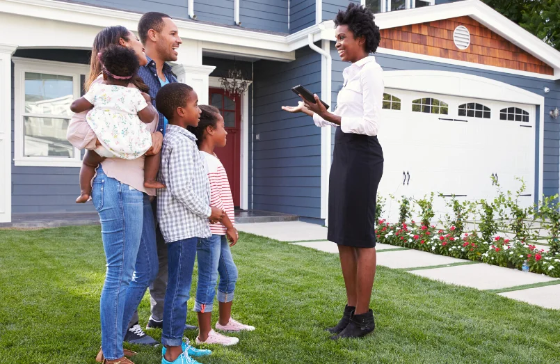 A real estate agent showing a house to a family