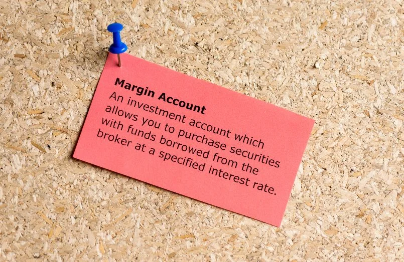 The word margin account typed on paper and pinned to a cork notice board