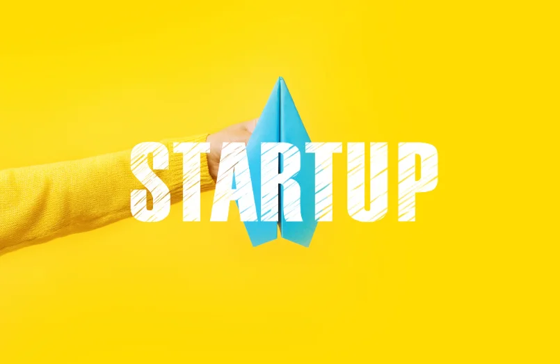Startup, a paper rocket on yellow background